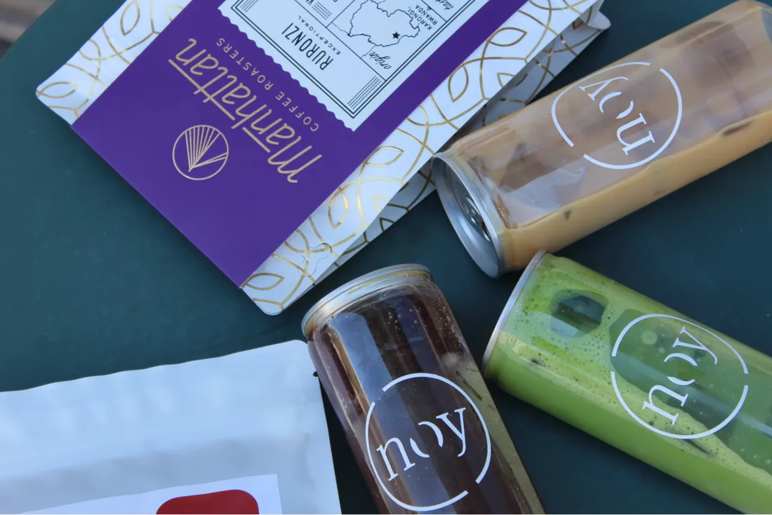 noy cold brew, iced latte and matcha in bottles next to a bag of beans
